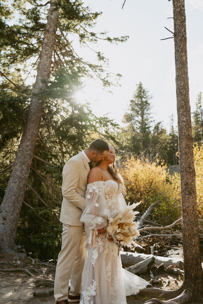 groom kissing the bride on the cheek