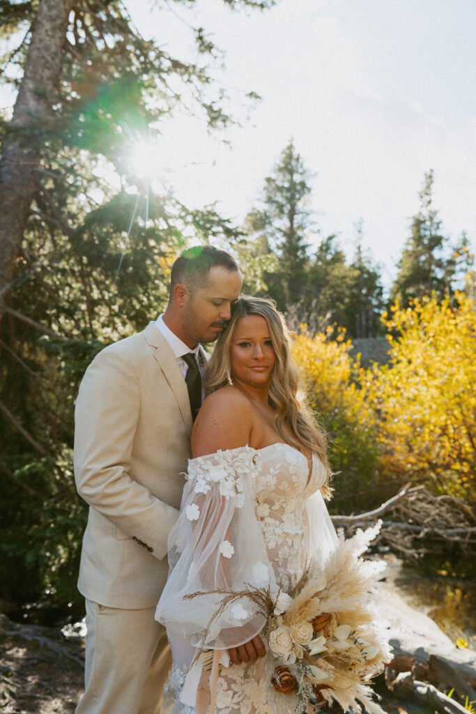 groom kissing the bride on the forehead