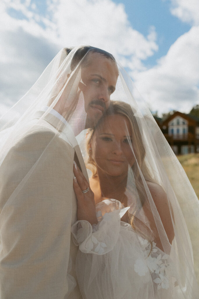 portrait of the bride and groom smiling at the camera