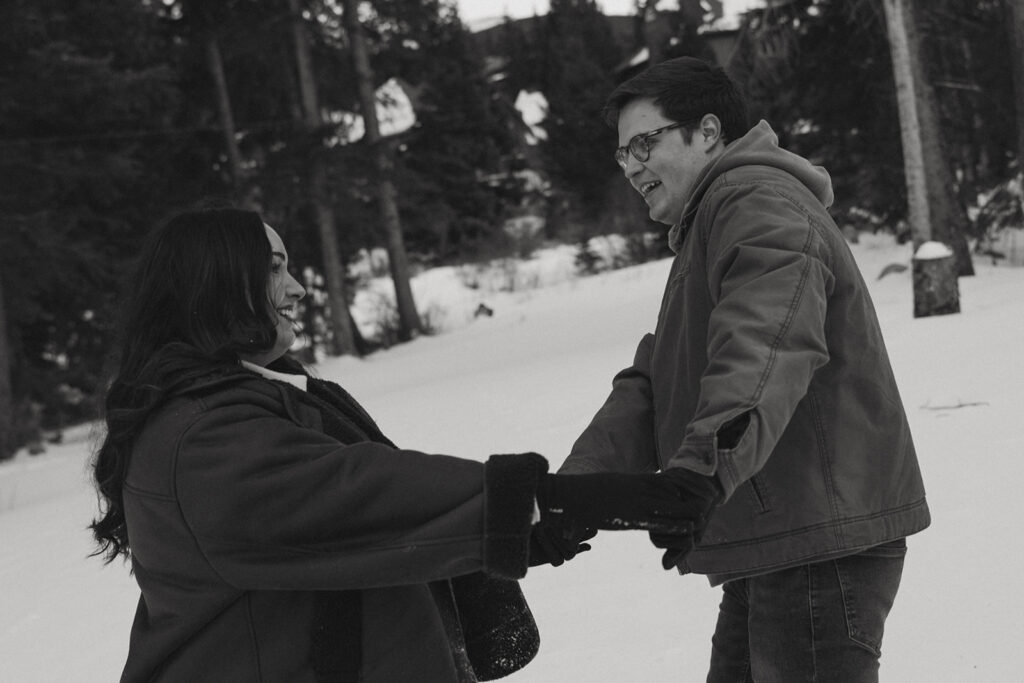 couple playing in the snow during their photoshoot