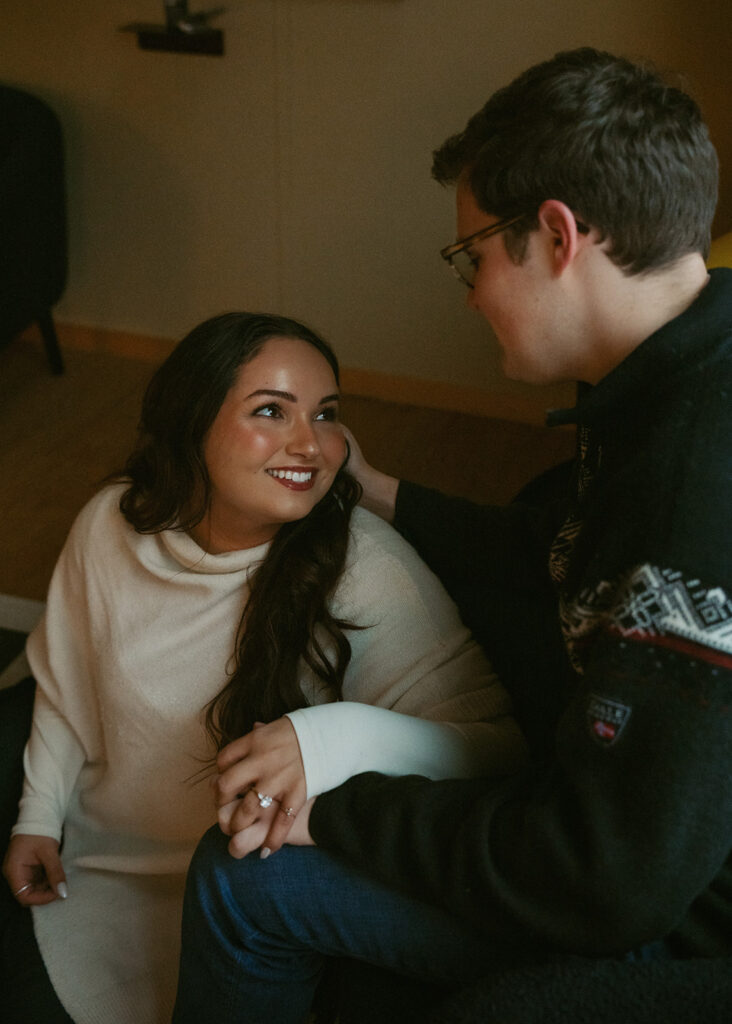 couple smiling with each other during their session