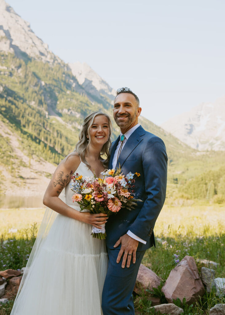 newly married couple smiling at the camera during their photoshoot