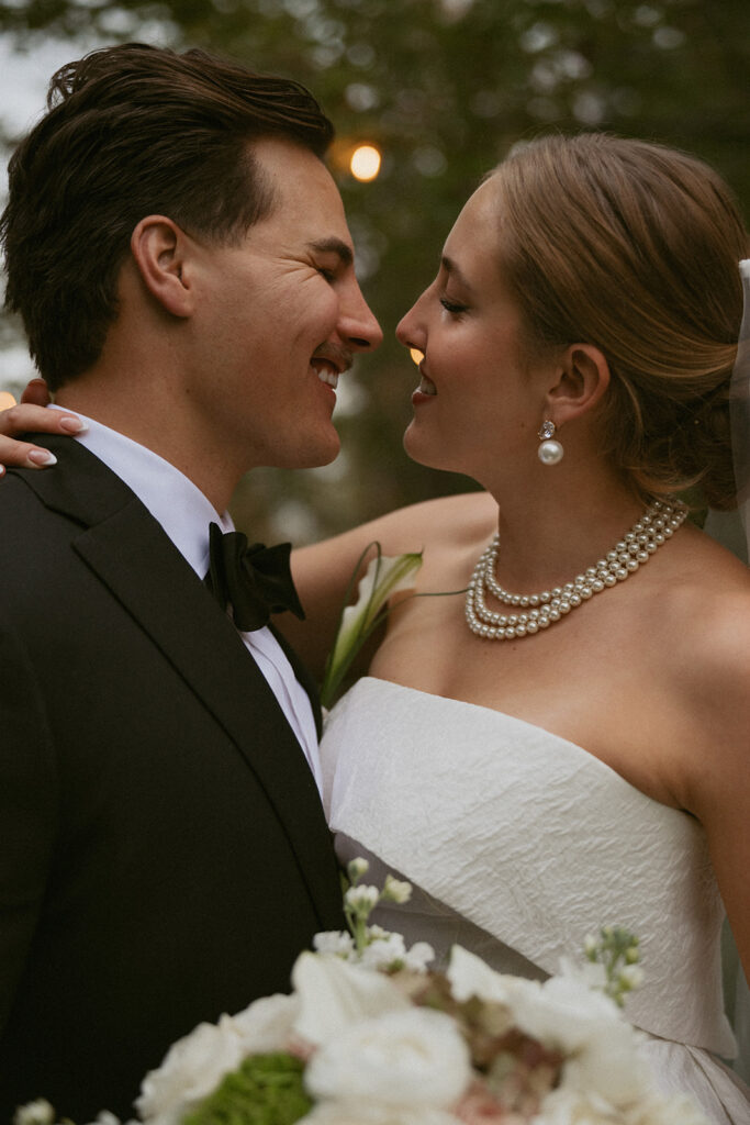bride and groom smiling at each other