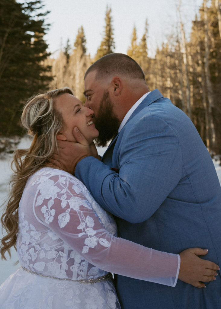 groom kissing the bride on the cheek