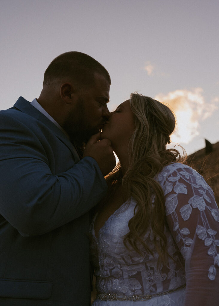cute picture of the bride and groom kissing
