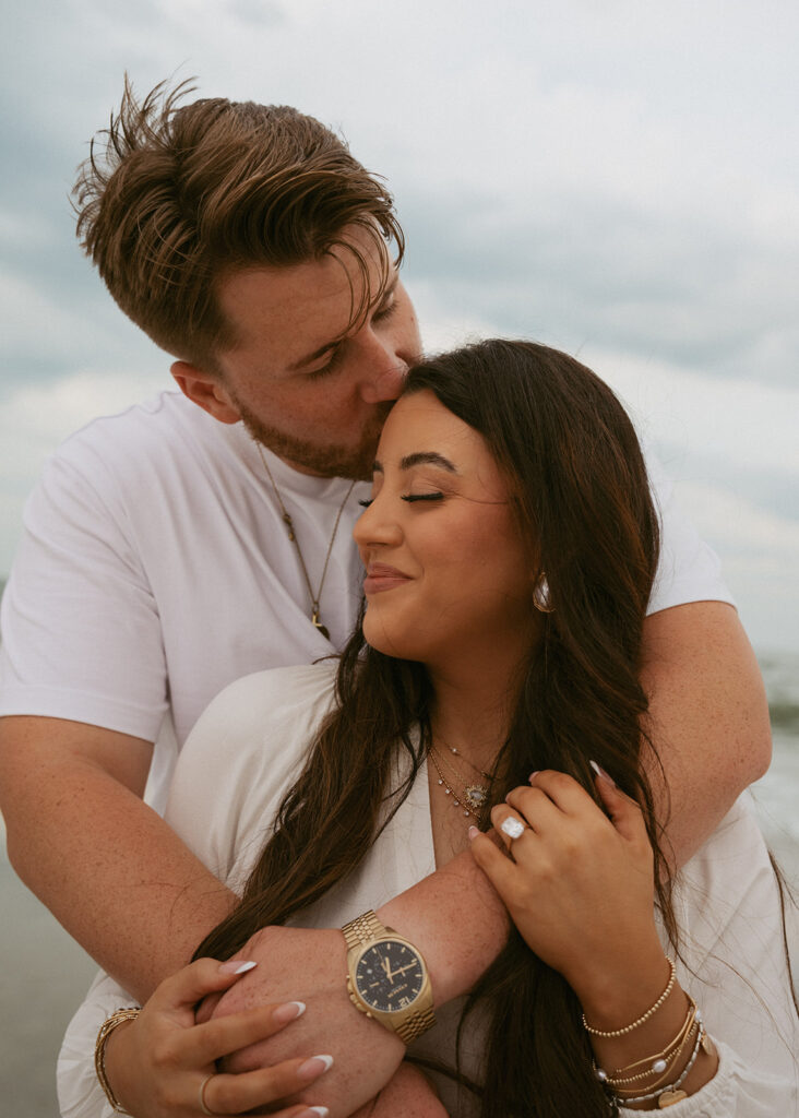 fiance kissing his fiance on the cheek