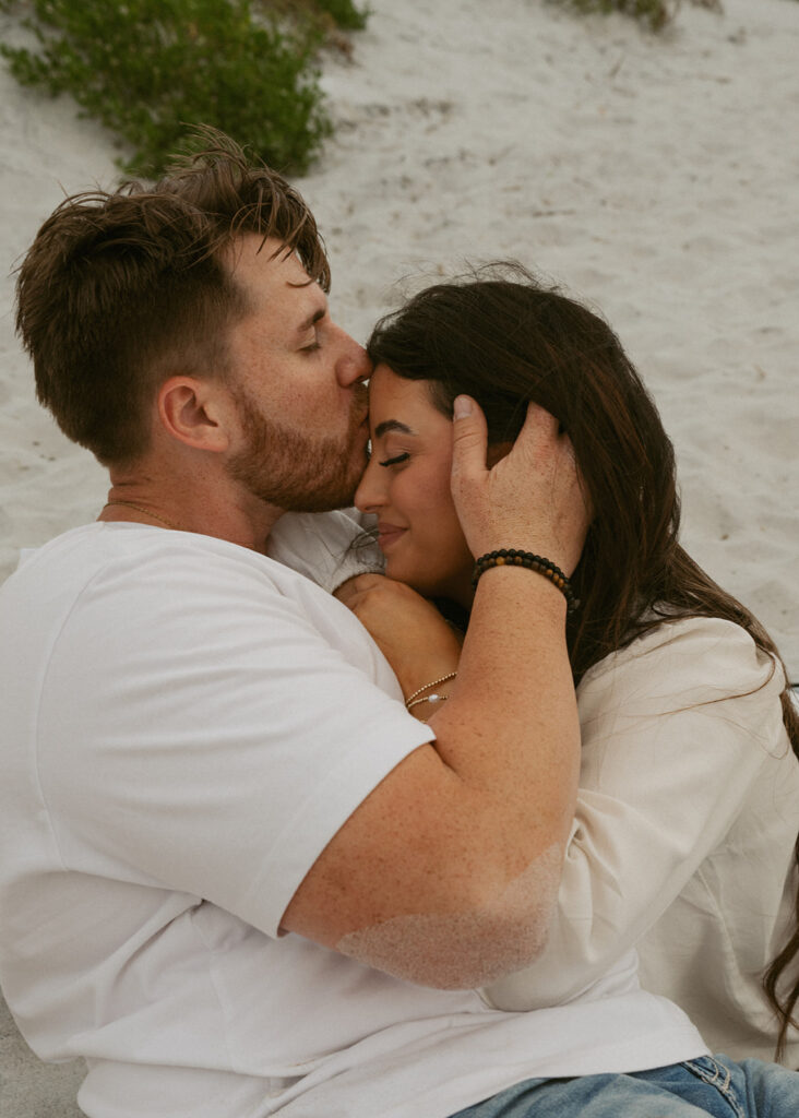 fiance kissing his fiance on the forehead