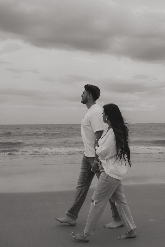 couple walking around the beach during their photoshoot