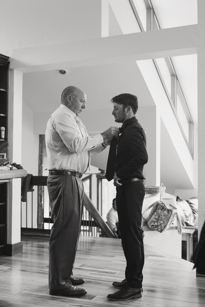 groom getting ready for his dream elopement in colorado