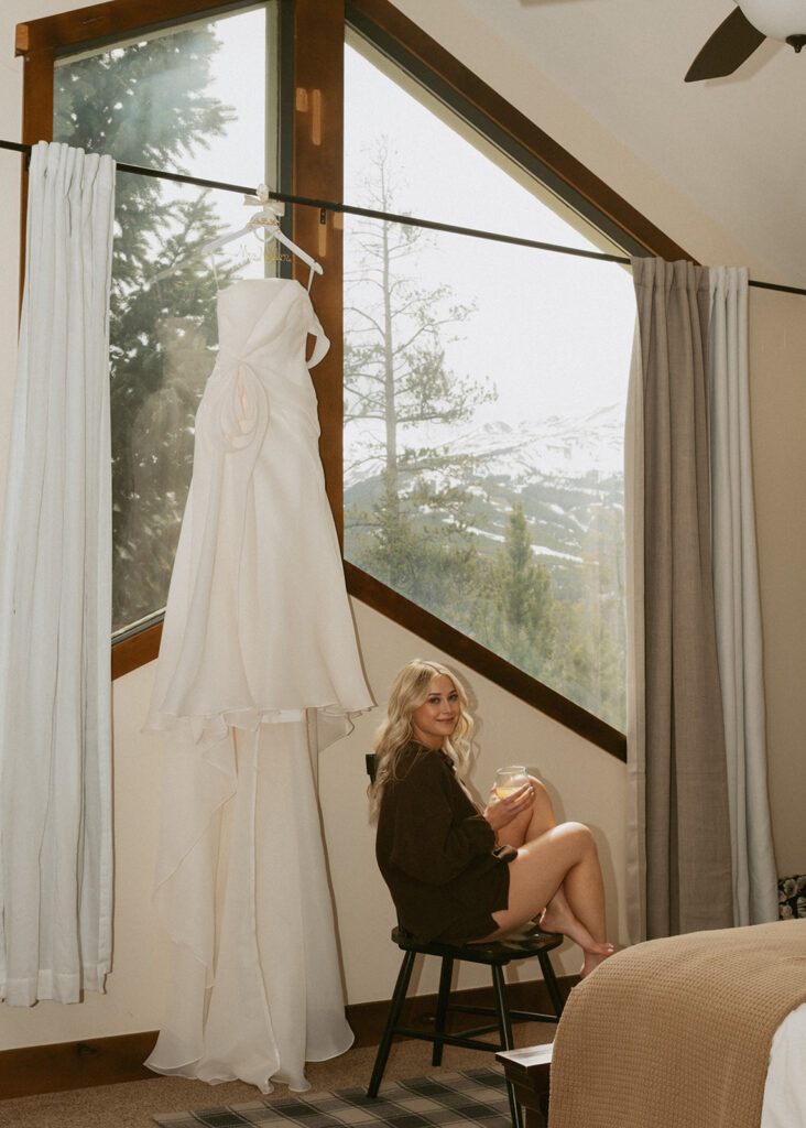 cute picture of the bride next to her wedding dress