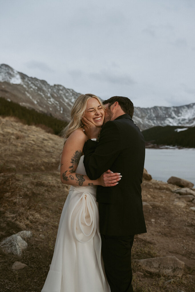 groom kissing the bride on the cheek