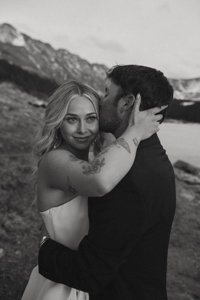 groom kissing the bride on the forehead