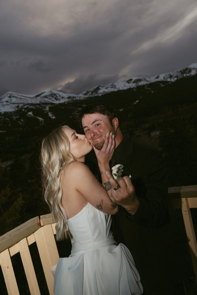 bride kissing the groom on the cheek