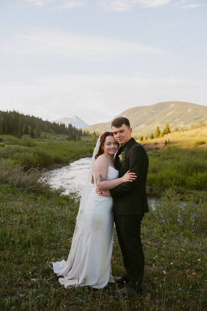 couple smiling at the camera during their photoshoot