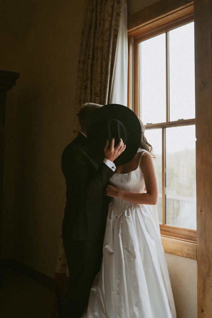 cute picture of the bride and groom kissing during their bridal portraits