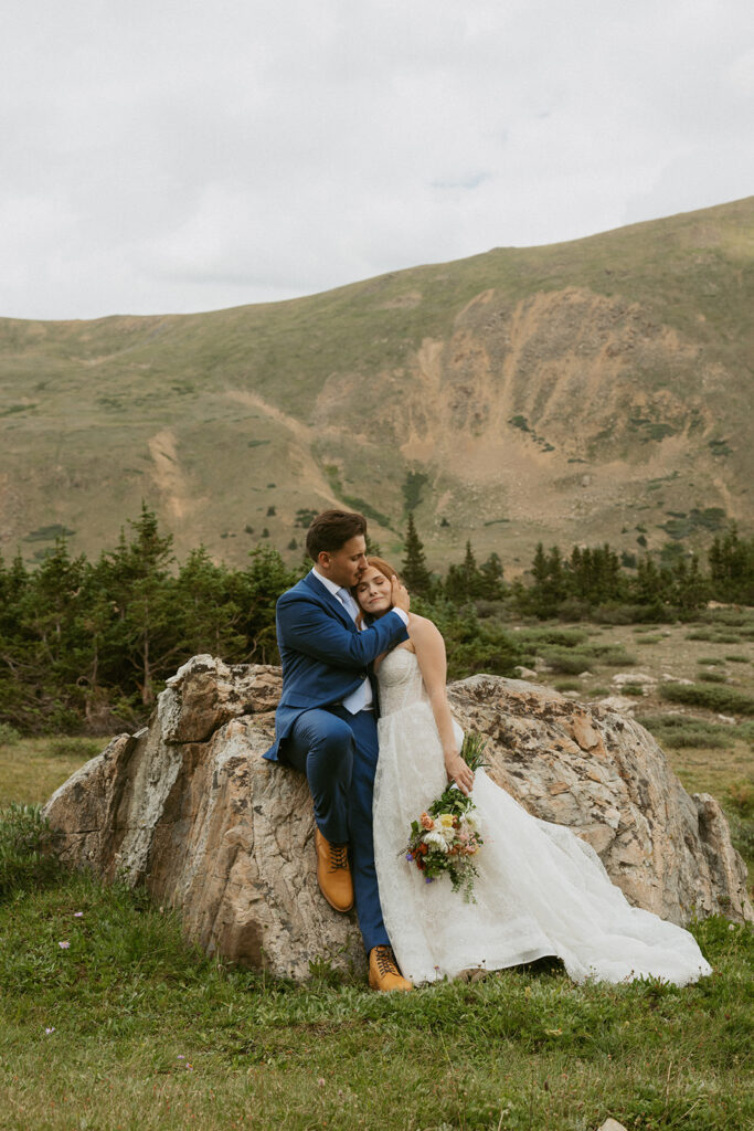 cute portrait of the groom kissing the bride on the forehead